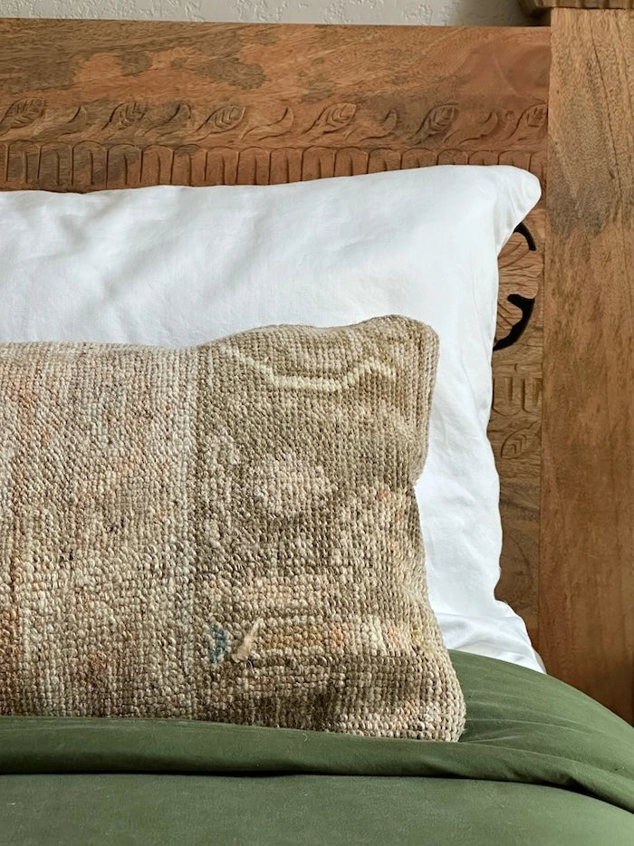 12x47 neutral lumbar pillow featuring tones of brown and tan with geometric designs