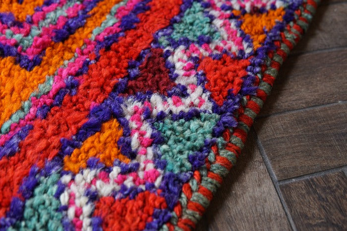 10.8 by 3.3 foot high pile turkish runner featuring bright pops of red and orange and three large medallions. Southwestern feel and style with a beautiful diamond pattern around the border