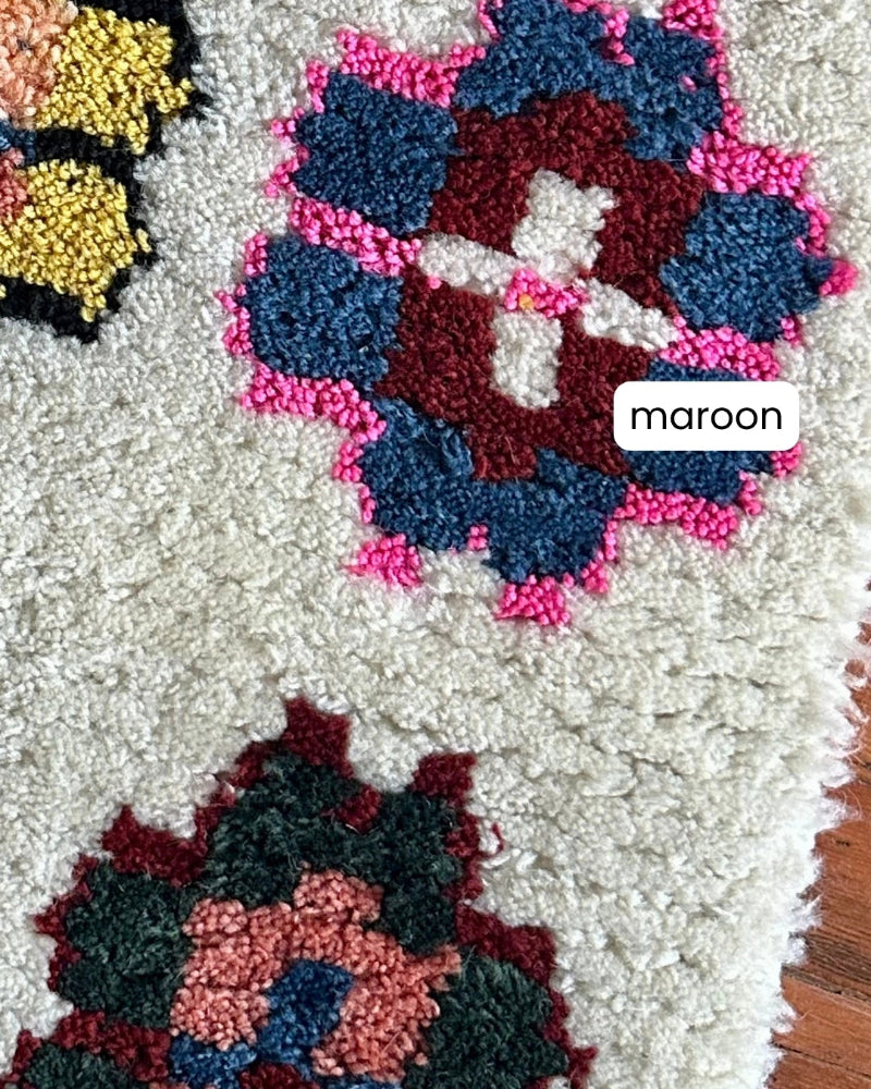 Close-up of a textured surface with maroon and pink floral patterns.