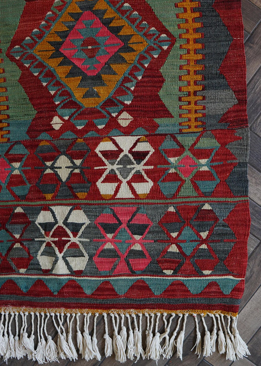 Colorful Turkish Kilim rug with large geometric central medallion