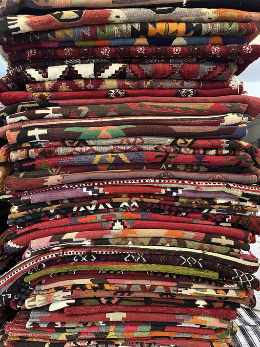 large pile of colorful Turkish rugs