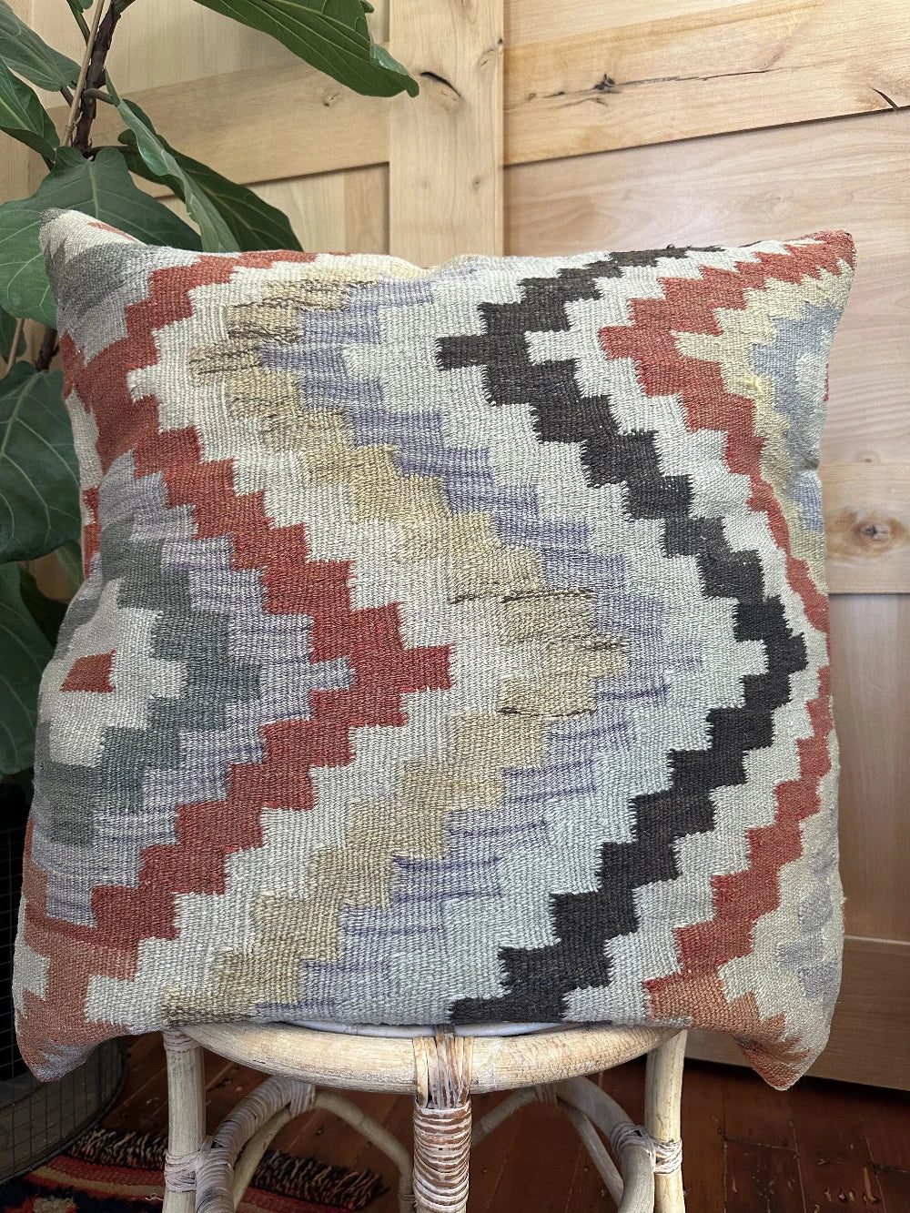 26 by 26 neutral geometric throw pillow featuring a zig-zag colorful pattern throughout