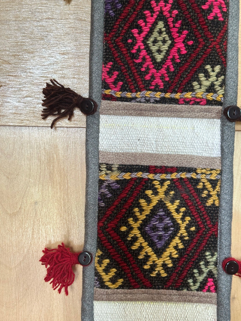 pink, yellow and rust colored fabric 3 pocket wall organizer made from turkish rug fragments