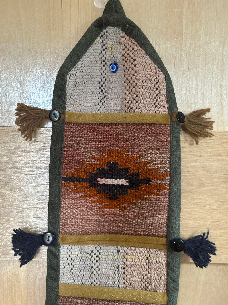 red, orange, and olive green colored fabric 3 pocket wall organizer and accessory made from turkish rug fragments