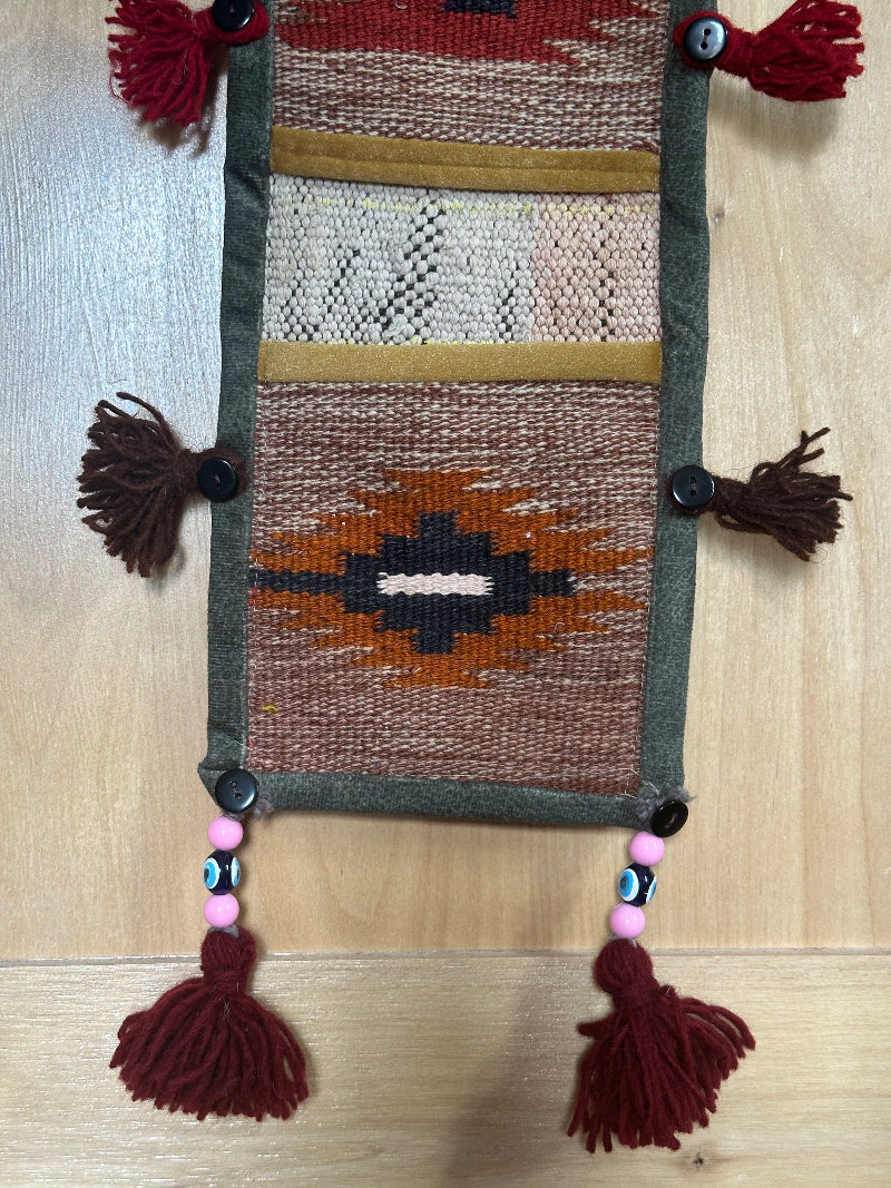 red, orange, and olive green colored fabric 3 pocket wall organizer and accessory made from turkish rug fragments