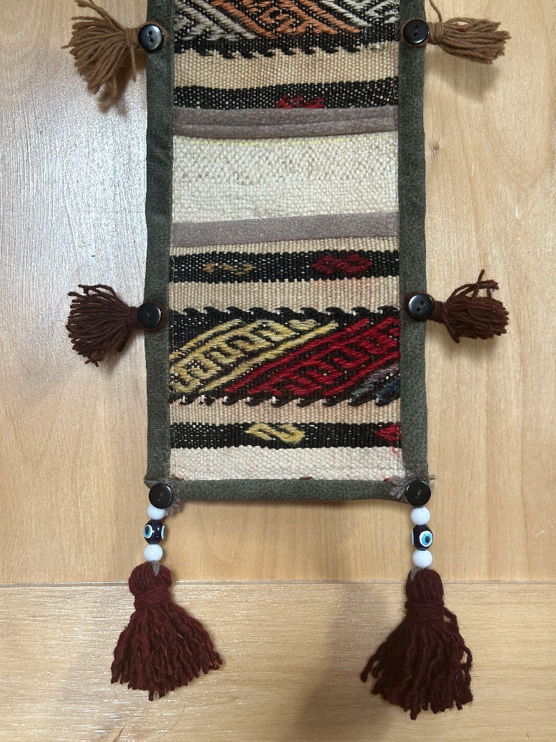 taupe, orange and olive green colored fabric 3 pocket wall organizer and accessory made from turkish rug fragments