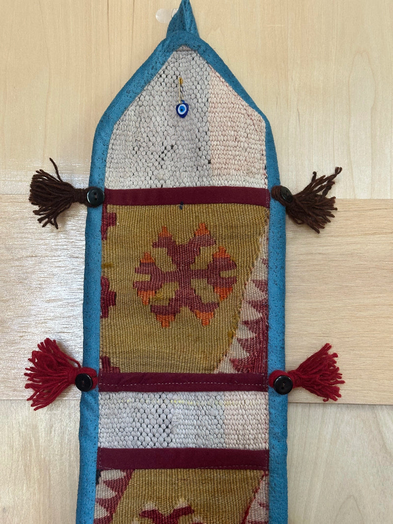olive green, maroon and teal colored fabric 3 pocket wall organizer and accessory made from turkish rug fragments