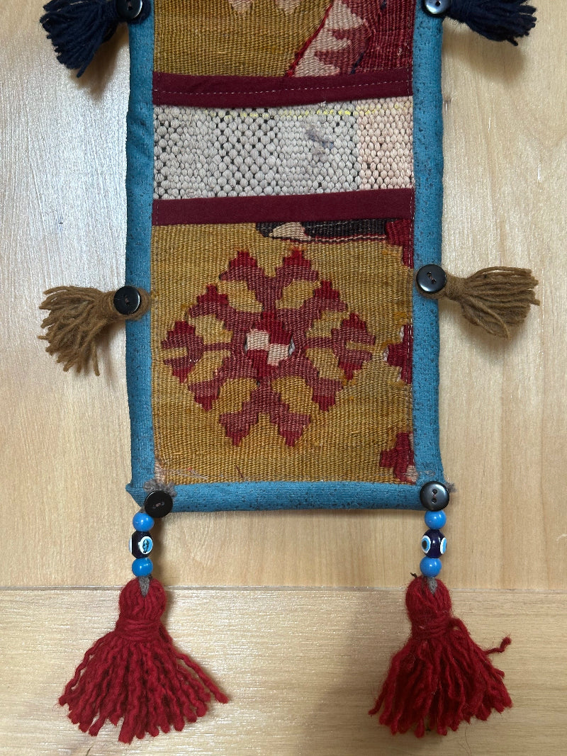 olive green, maroon and teal colored fabric 3 pocket wall organizer and accessory made from turkish rug fragments