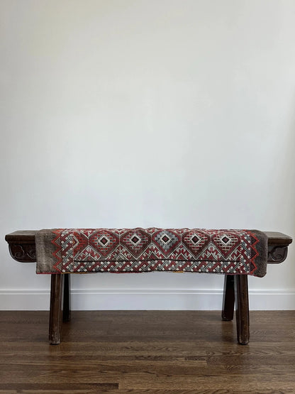 Mini Turkish Rug featuring pops of red and light blue with a repeating diamond pattern throughout