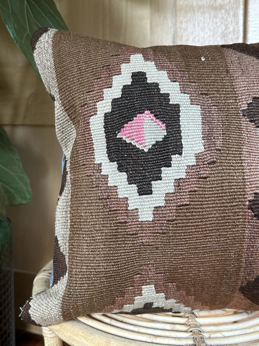 Handwoven brown Turkish throw pillow, 16x16 inches, wool front with geometric design and pops of light grey and pink, cotton backing—boho home decor.