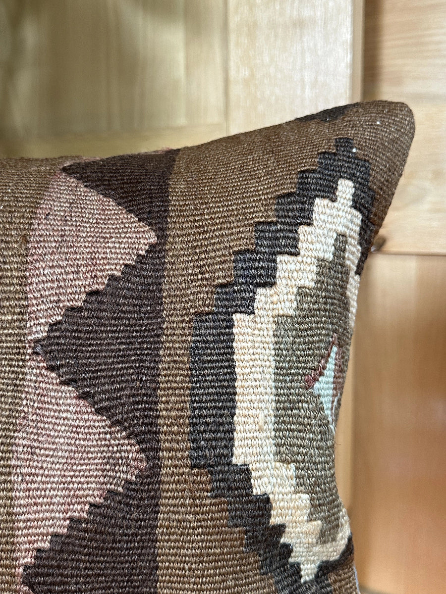 Handwoven brown Turkish throw pillow, 16x16 inches, wool front with geometric design and pops of light grey and pink, cotton backing—boho home decor.