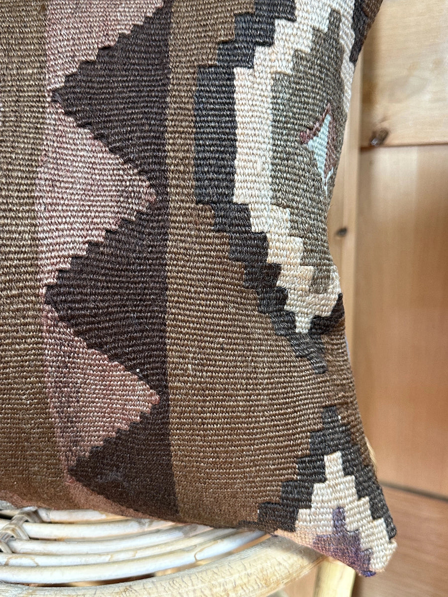 Handwoven brown Turkish throw pillow, 16x16 inches, wool front with geometric design and pops of light grey and pink, cotton backing—boho home decor.