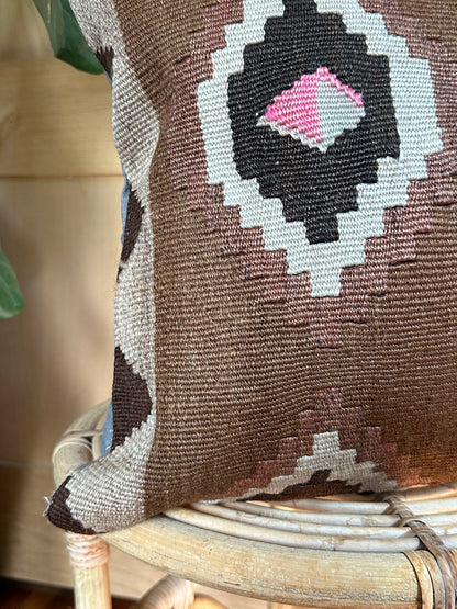 Handwoven brown Turkish throw pillow, 16x16 inches, wool front with geometric design and pops of light grey and pink, cotton backing—boho home decor.