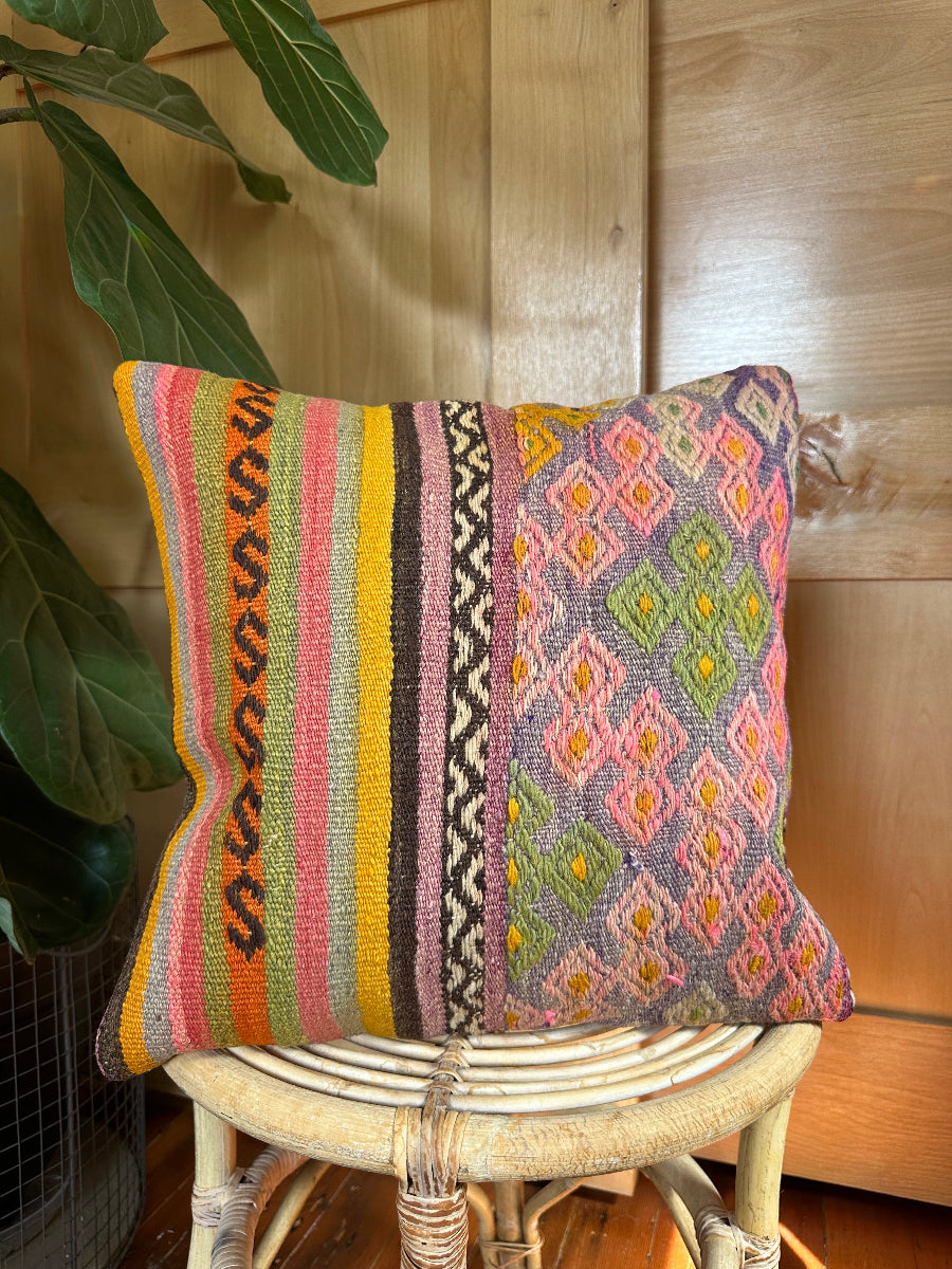 Handwoven multi-colored Turkish throw pillow, 16x16 inches, wool front with geometric design and pops of yellow and orange, cotton backing—boho home decor.