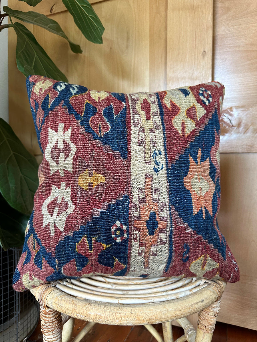 Handwoven red and green Turkish throw pillow, 16x16 inches, wool front with geometric design and pops of light blue and maroon, cotton backing—boho home decor.