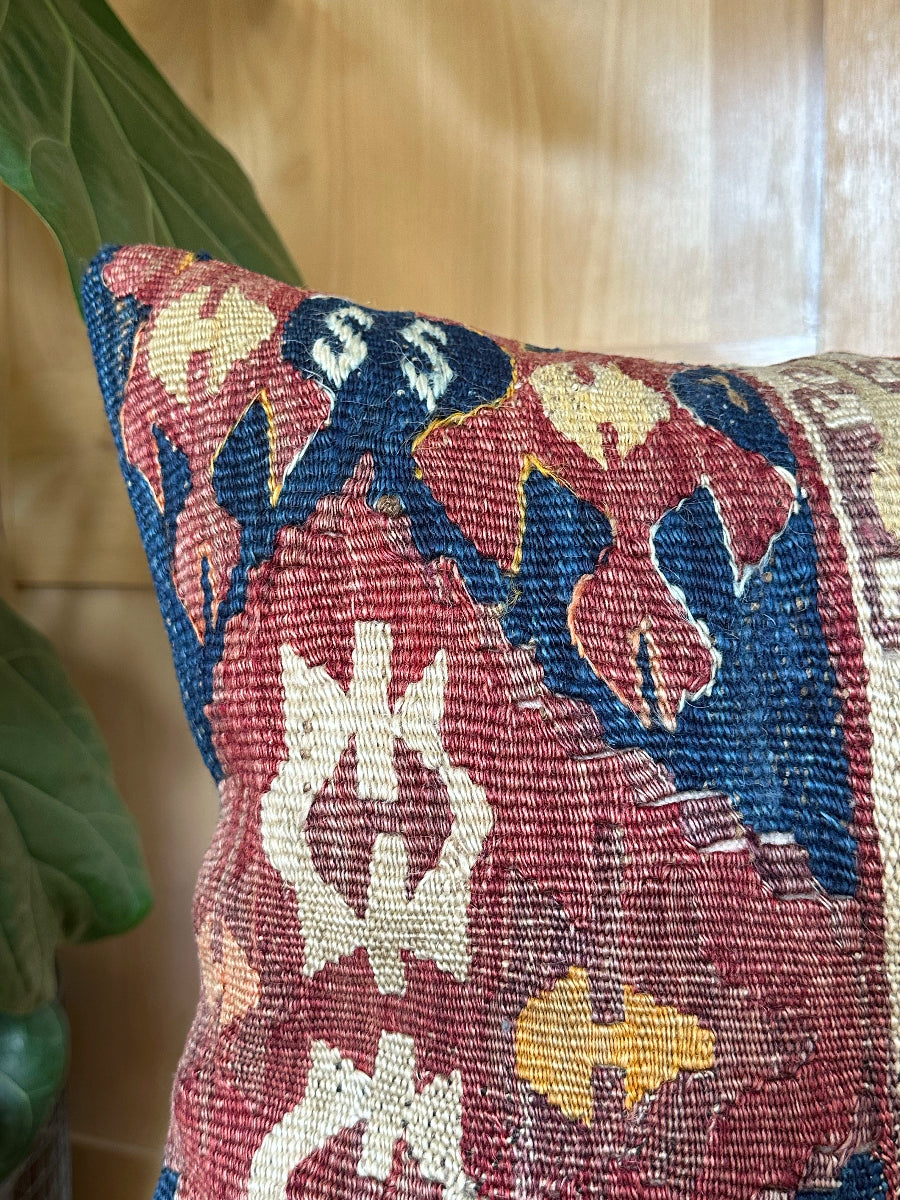 Handwoven red and green Turkish throw pillow, 16x16 inches, wool front with geometric design and pops of light blue and maroon, cotton backing—boho home decor.