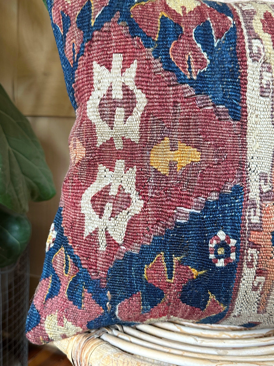 Handwoven red and green Turkish throw pillow, 16x16 inches, wool front with geometric design and pops of light blue and maroon, cotton backing—boho home decor.