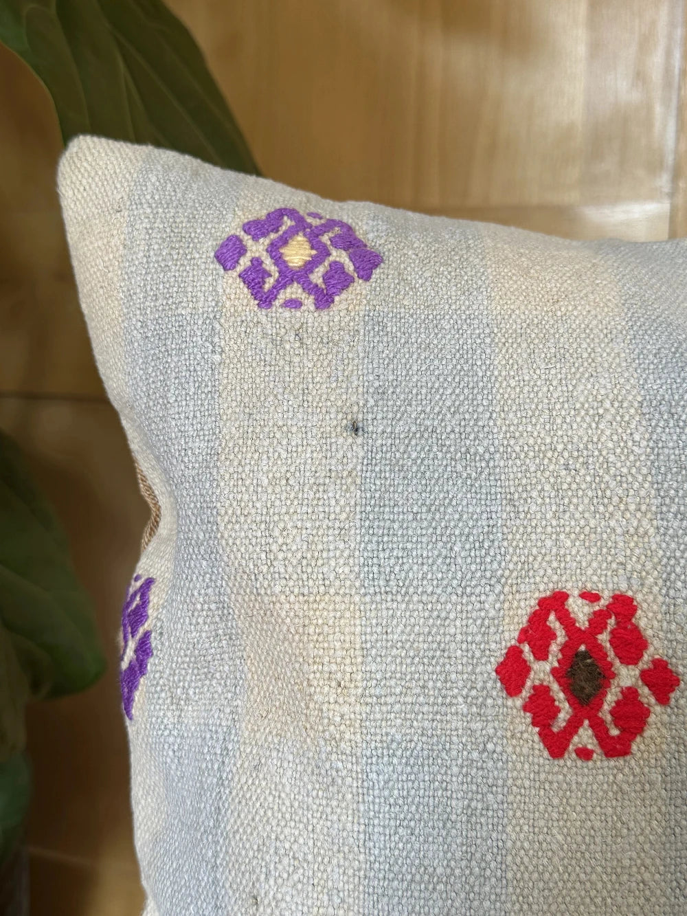 16 by 16 cream and light blue turkish throw pillow featuring purple, red and green embroidered flowers throughout