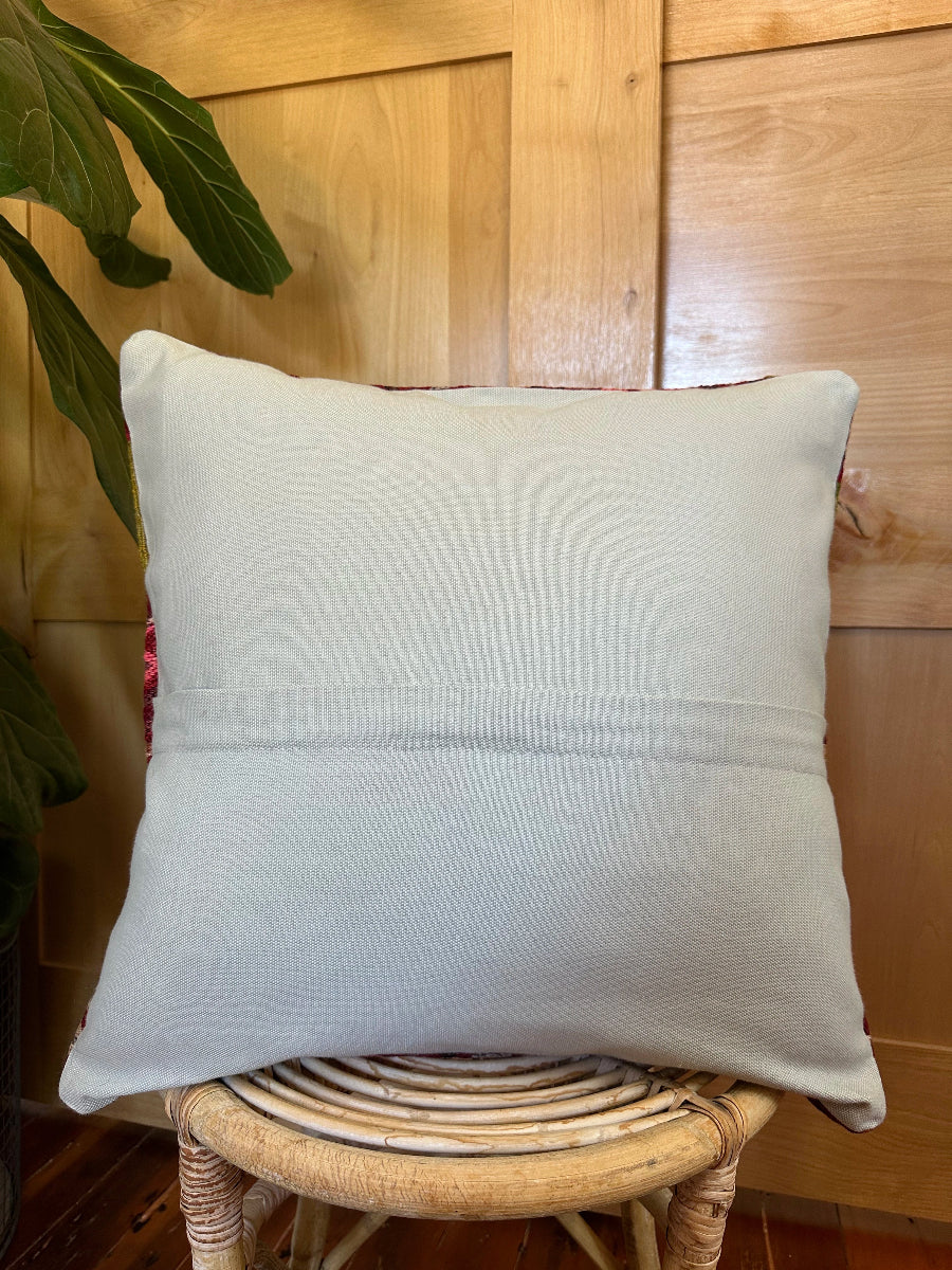 Handwoven red and green Turkish throw pillow, 20x20 inches, wool front with striped design and pops of white and pink, cotton backing—boho home decor.