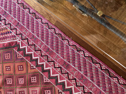 Flatwoven Turkish cicim are rug featuring geometric borders and fields throughout and a bright pink all over color with small accents of light blue, purple, yellow, green and white