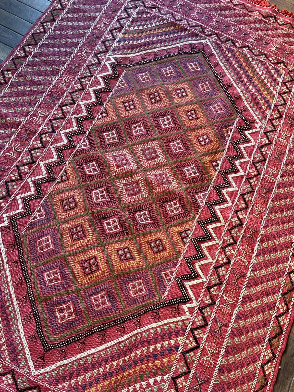 Flatwoven Turkish cicim are rug featuring geometric borders and fields throughout and a bright pink all over color with small accents of light blue, purple, yellow, green and white