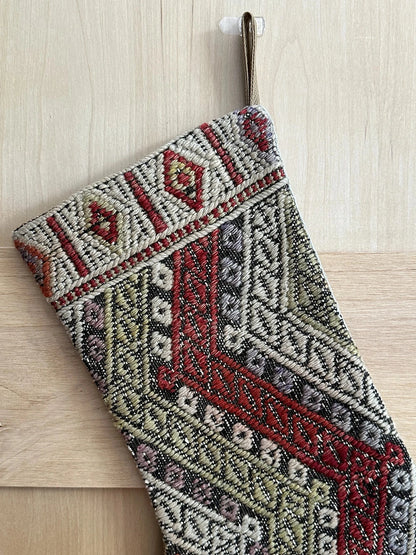 handmade and colorful Turkish Christmas stocking featuring red white and green striped geometric design