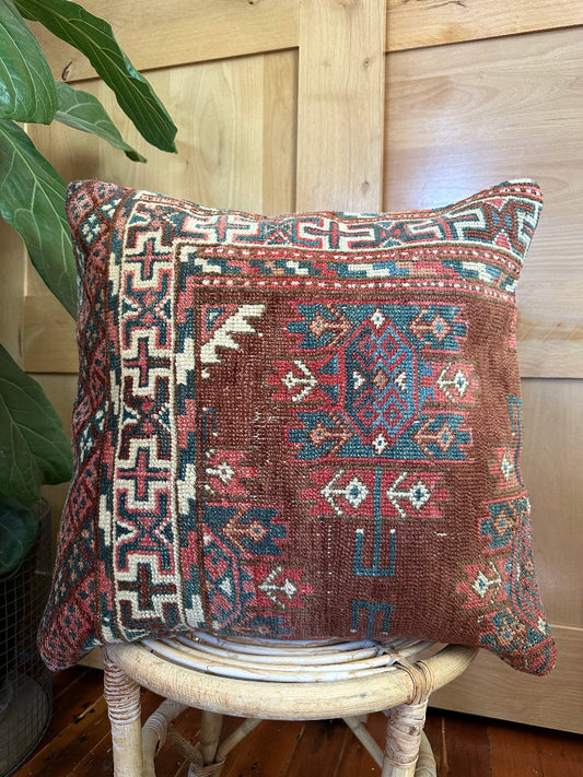 Hand-knotted red and green Turkish throw pillow, 20x20 inches, wool front with geometric design and pops of blue and emerald green, cotton backing—boho home decor.