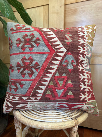 Handwoven red and brown geometric Turkish throw pillow, 20x20 inches, wool front with pops of white and green, cotton backing—boho home decor.