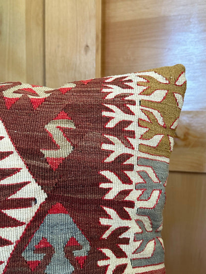 Handwoven red and brown geometric Turkish throw pillow, 20x20 inches, wool front with pops of white and green, cotton backing—boho home decor.