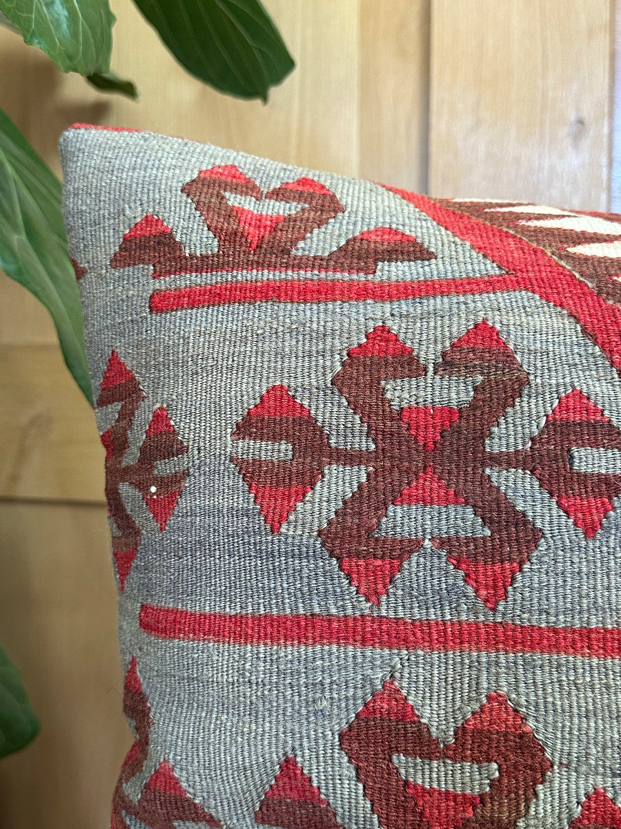 Handwoven red and brown geometric Turkish throw pillow, 20x20 inches, wool front with pops of white and green, cotton backing—boho home decor.