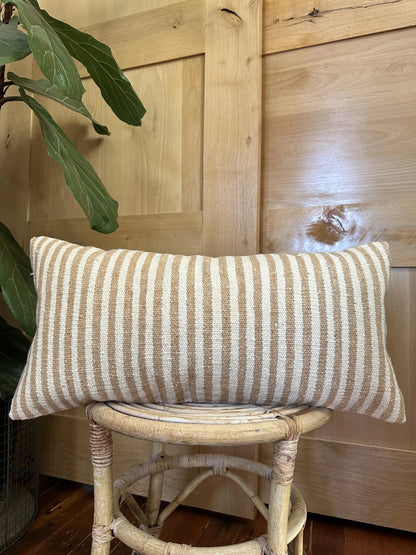 12 by 24 cream and brown lumbar pillow featuring an all over vertical striped pattern