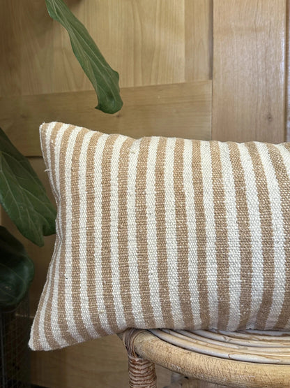 12 by 24 cream and brown lumbar pillow featuring an all over vertical striped pattern