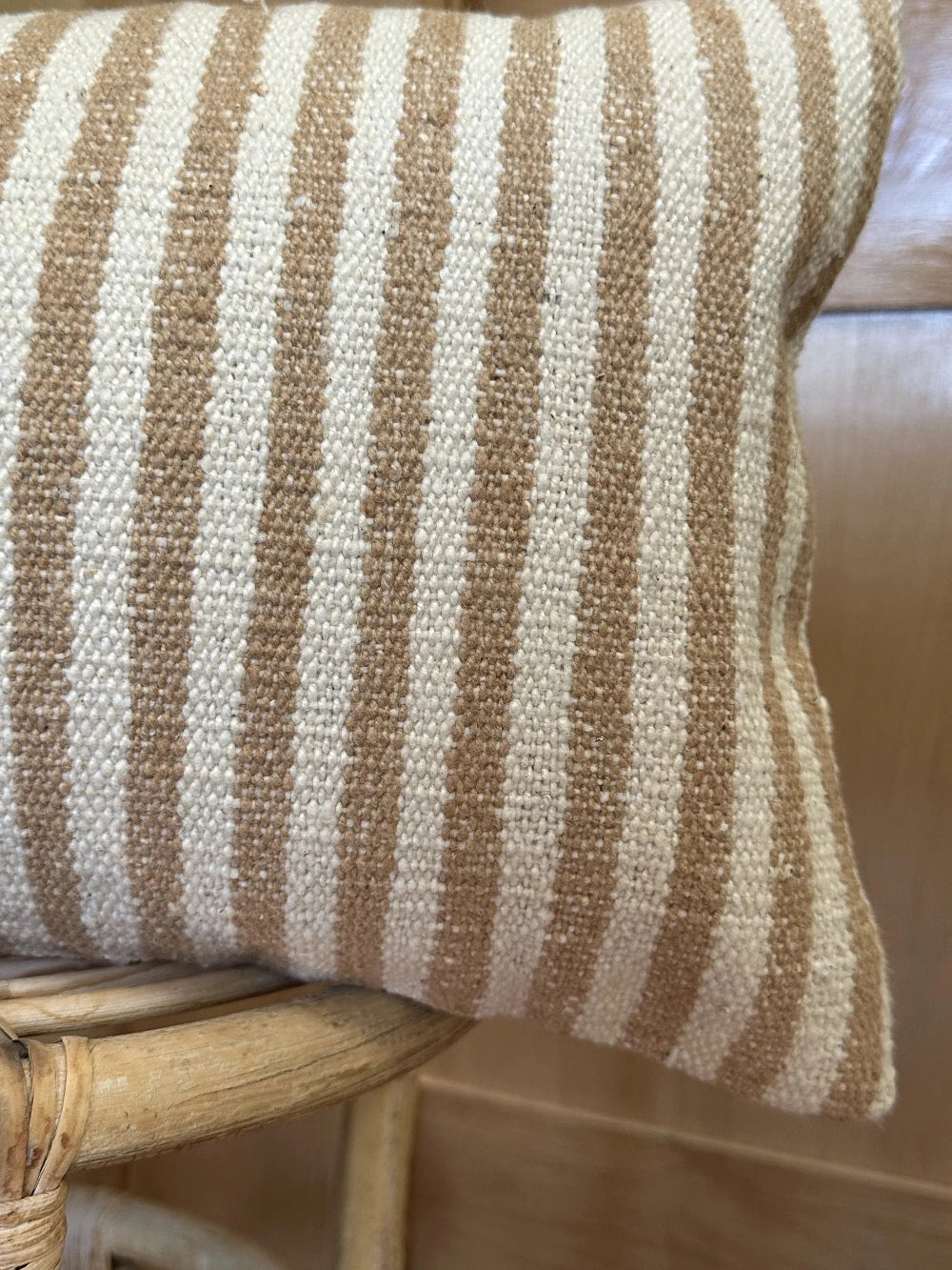 12 by 24 cream and brown lumbar pillow featuring an all over vertical striped pattern