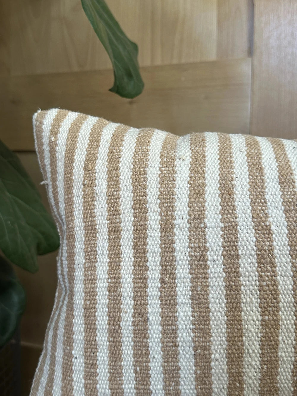 12 by 24 cream and brown lumbar pillow featuring an all over vertical striped pattern