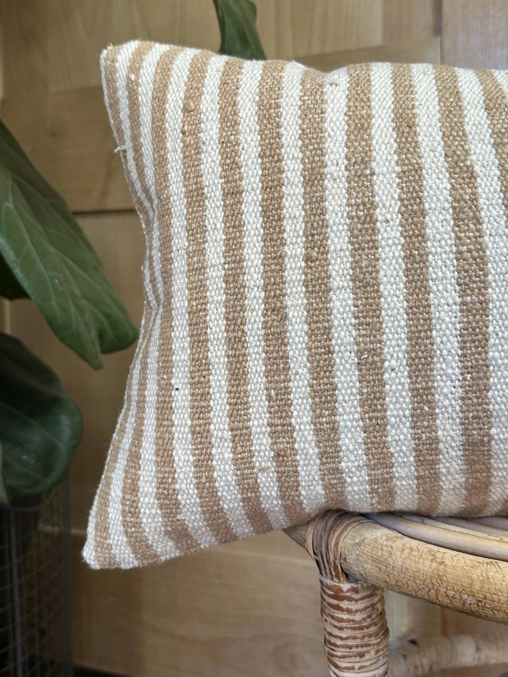 12 by 24 cream and brown lumbar pillow featuring an all over vertical striped pattern