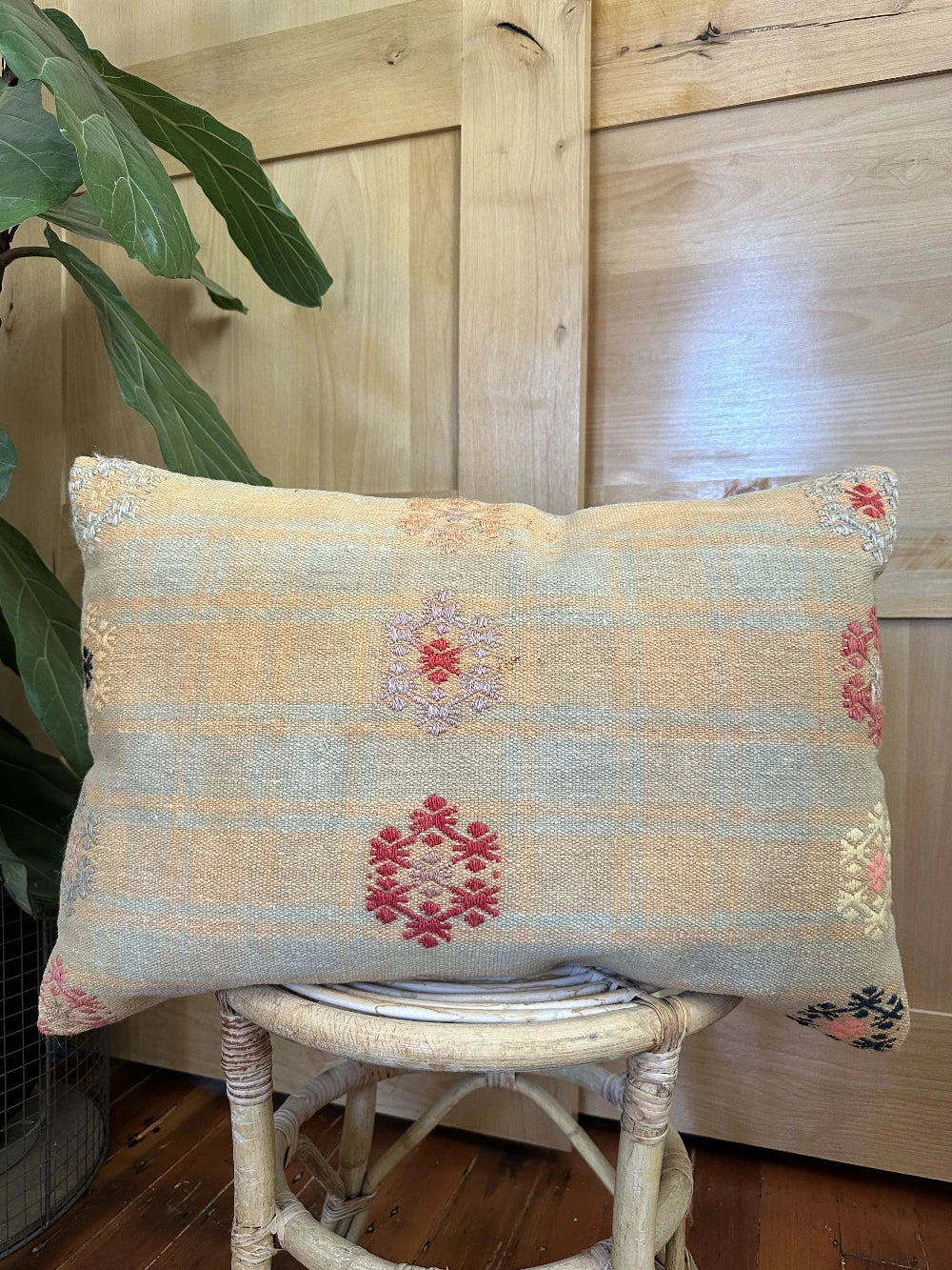 16 by 24 yellow and light blue lumbar pillow featuring floral embroidery