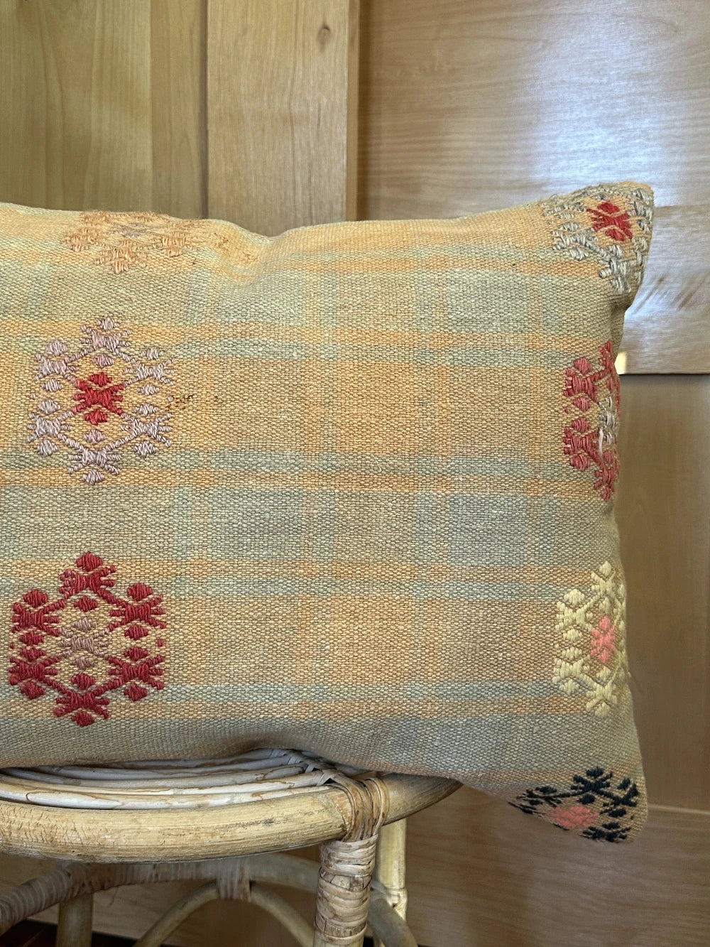 16 by 24 yellow and light blue lumbar pillow featuring floral embroidery