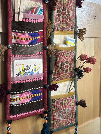 Handmade Turkish rug wall organizer storing supplies & flowers. Upcycled vintage textile art by High Pile Designs.