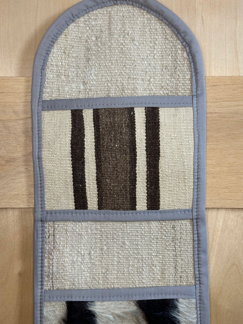 Decorative, handmade Turkish rug wall organizer with neutral stripe designs and 3 storage pockets. Upcycled vintage textile art by High Pile Designs.