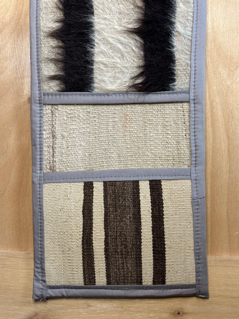 Decorative, handmade Turkish rug wall organizer with neutral stripe designs and 3 storage pockets. Upcycled vintage textile art by High Pile Designs.