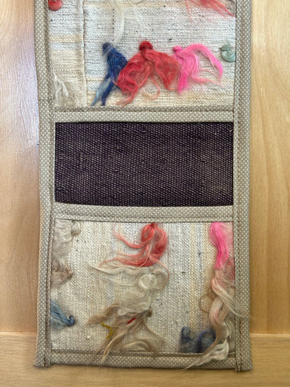 Decorative, handmade Turkish rug wall organizer with vibrant stripe designs and 3 storage pockets. Upcycled vintage textile art by High Pile Designs. 