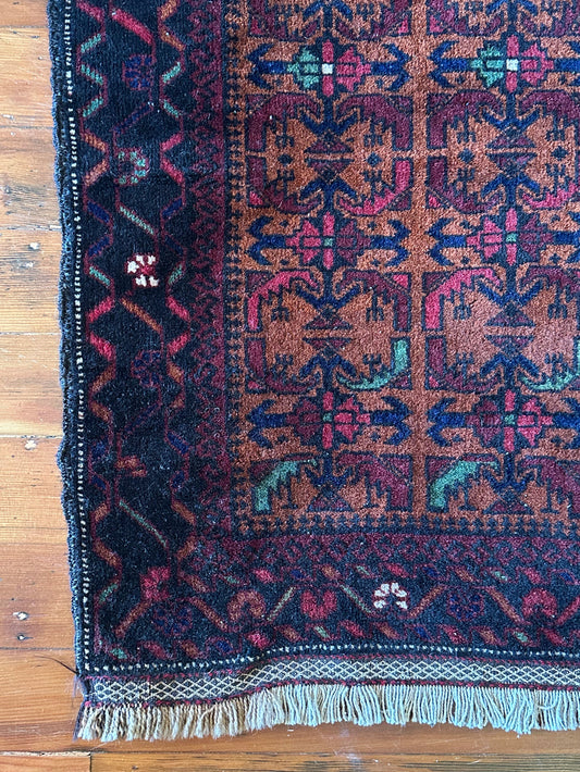 Decorative rug with intricate patterns on a wooden floor