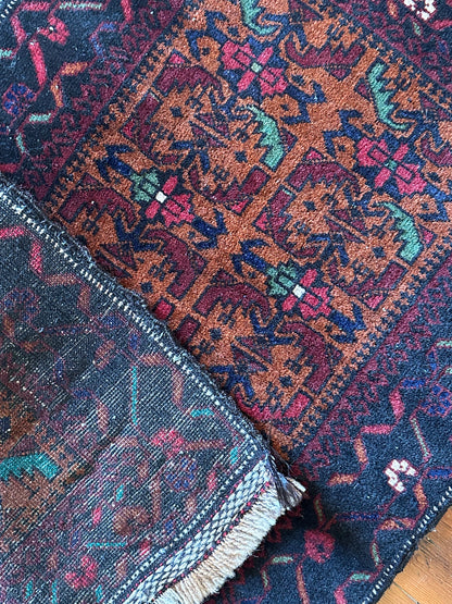 Decorative rug with intricate patterns on a wooden floor