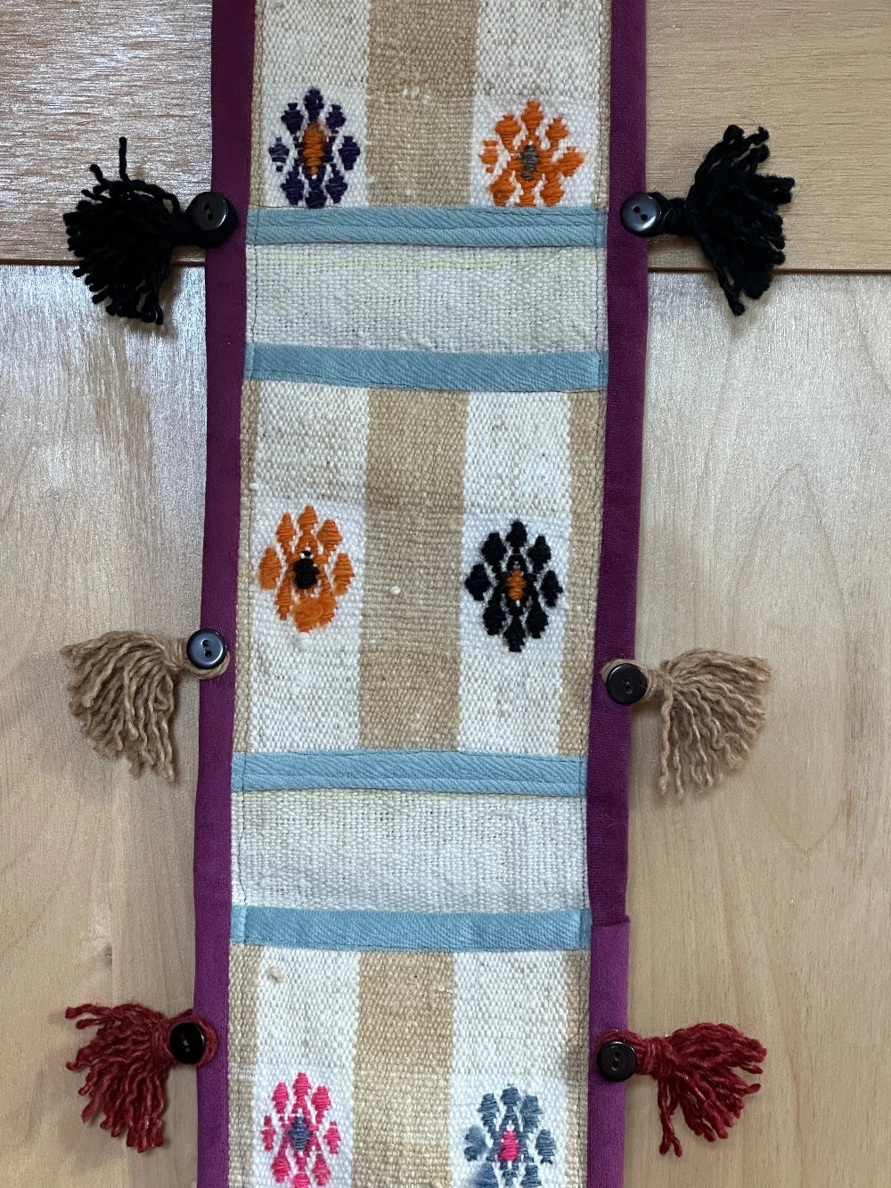 3 pocket hanging wall organizer made from Turkish rug fragments featuring embroidered floral pockets