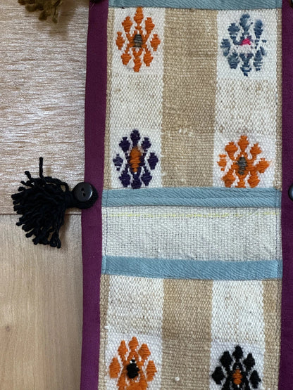 3 pocket hanging wall organizer made from Turkish rug fragments featuring embroidered floral pockets