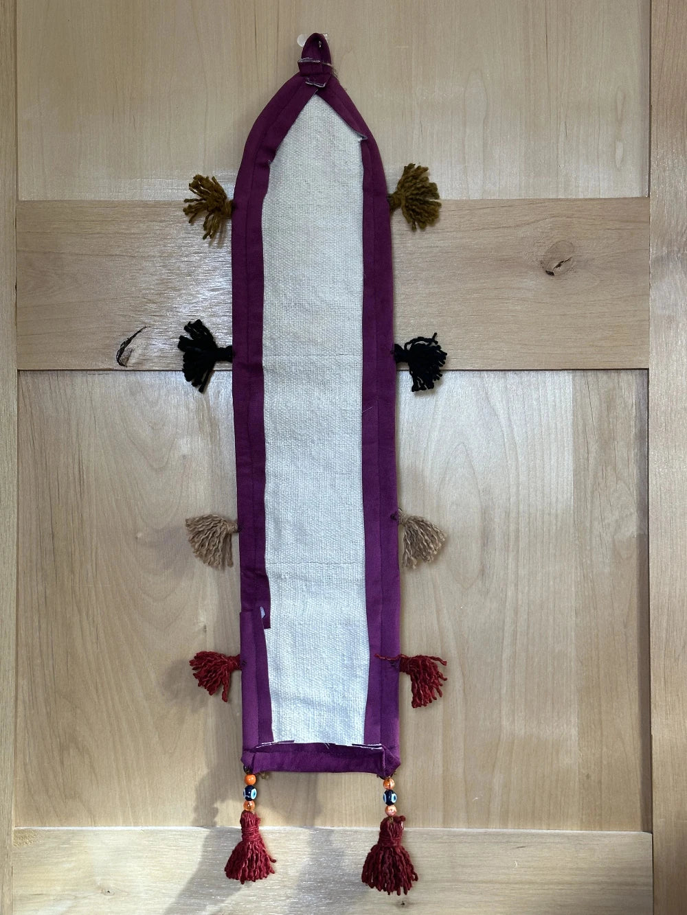 3 pocket hanging wall organizer made from Turkish rug fragments featuring embroidered floral pockets