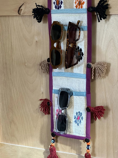 3 pocket hanging wall organizer made from Turkish rug fragments featuring embroidered floral pockets