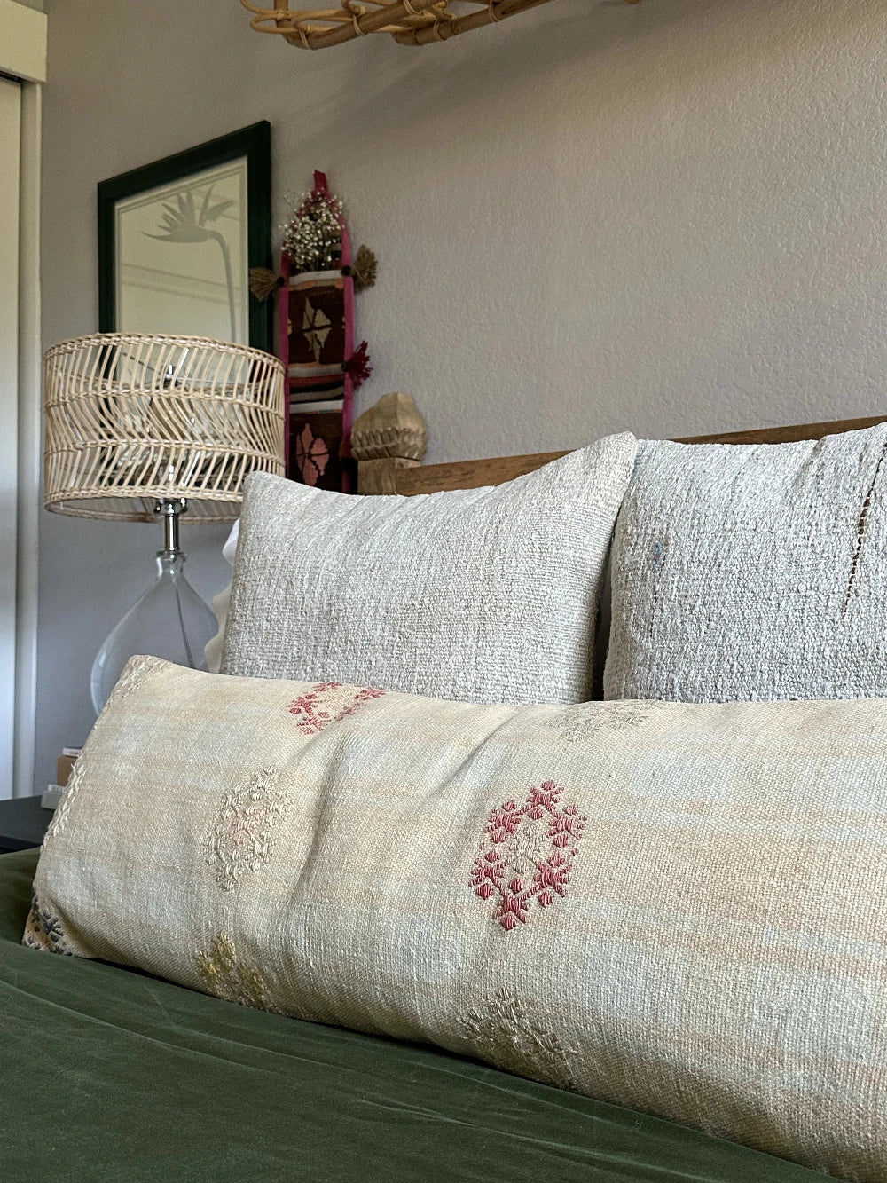 12 by 36 neutral lumbar pillow featuring light yellow and blue plaid and colorful floral embroidery throughout