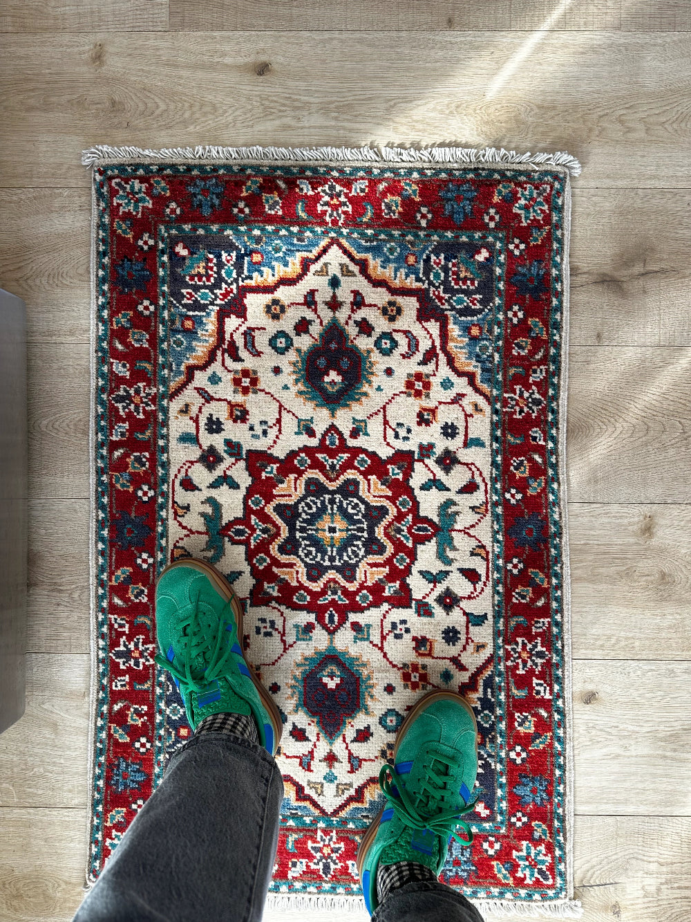 Handknotted two by three foot mini Kazak rug with intricate geometric patterns, rich red and deep blue hues, and a durable low-pile wool construction. Made to order in custom sizes, perfect for adding a bold, traditional touch to vintage, classic, or eclectic home décor.