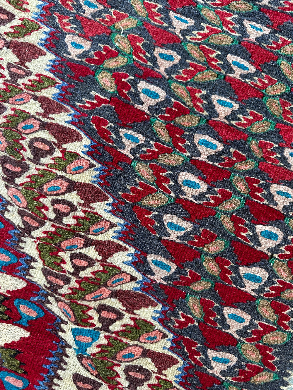 Handwoven Senneh Kilim rug, featuring intricate geometric patterns, a central medallion design, and rich earthy red, deep blue, and neutral tones. Flat-woven wool rug with fine detailing and a slit tapestry weave, perfect for bohemian, modern, or traditional home décor.